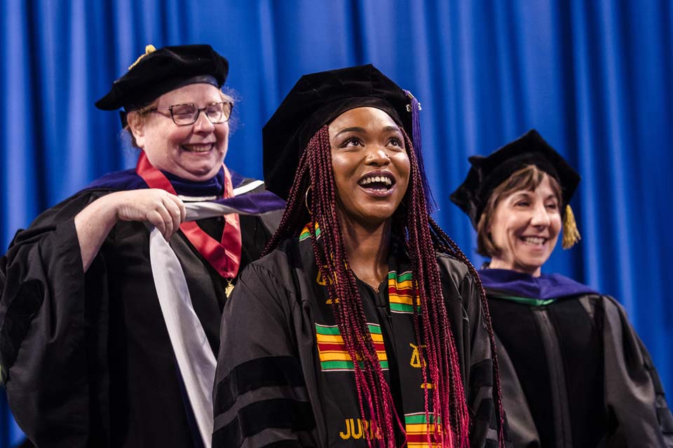 A graduate of the School of Law is hooded during the recommencement at Chaifetz Arena on May 18, 2023. Photo by Sarah Conroy.