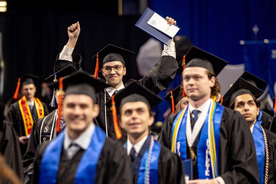 A School of Science and Engineering graduate celebrates during his precommencement ceremony on May 19, 2023. Photo by Sarah Conroy.