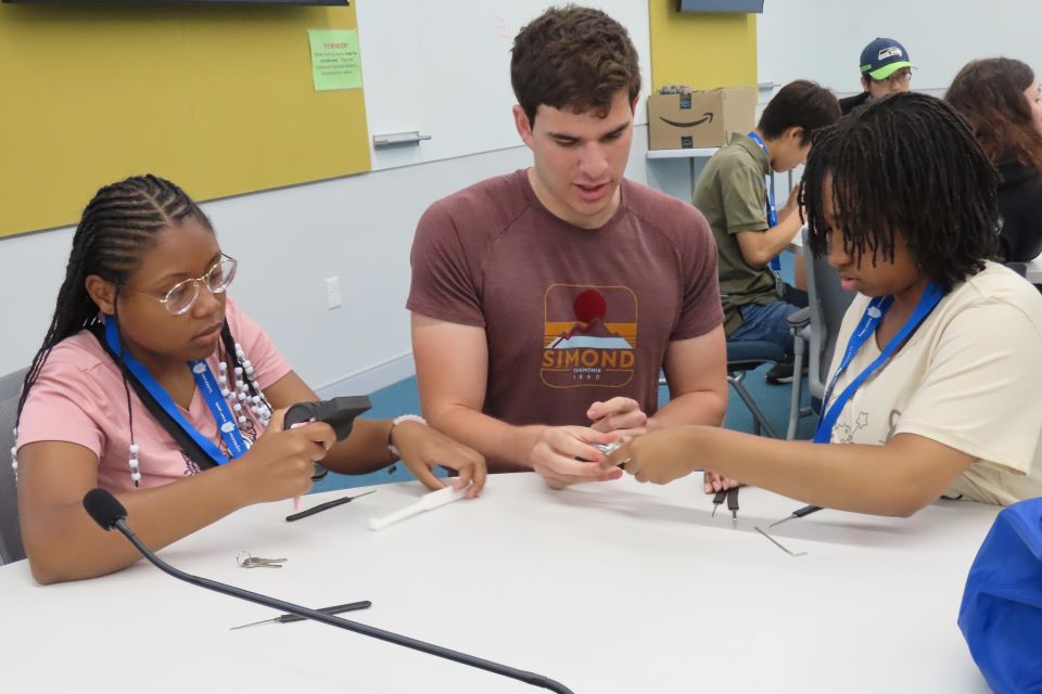 Beautiful King, left, and Kiran Rudd, work on picking locks during a CHROME lab activity. Photo by Maggie Rotermund.