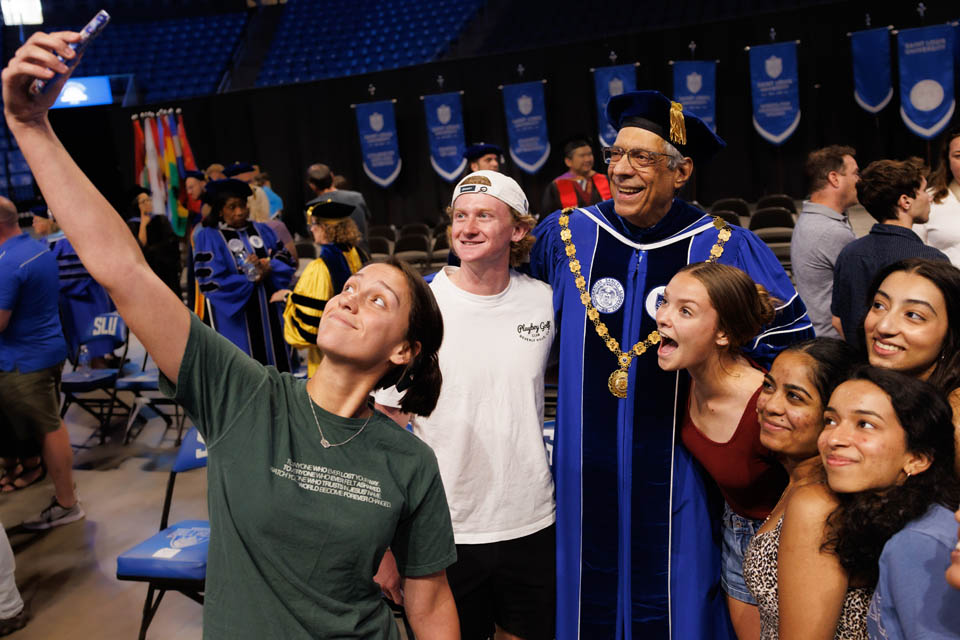President Fred P. Pestello, Ph.D., takes a selfie with new students after Convocation at Chaifetz Arena on Saturday, Aug. 19, 2023. Photo by Sarah Conroy.