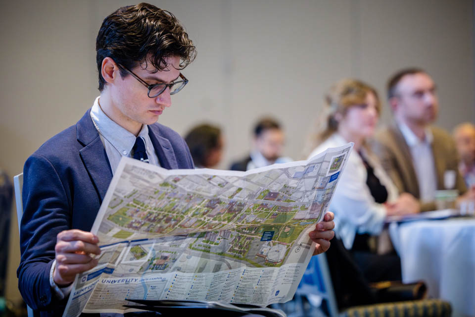 A new faculty member familiarizes himself with the SLU campus map during the new faculty orientation on Wednesday, Aug. 16. Photo by Sarah Conroy.