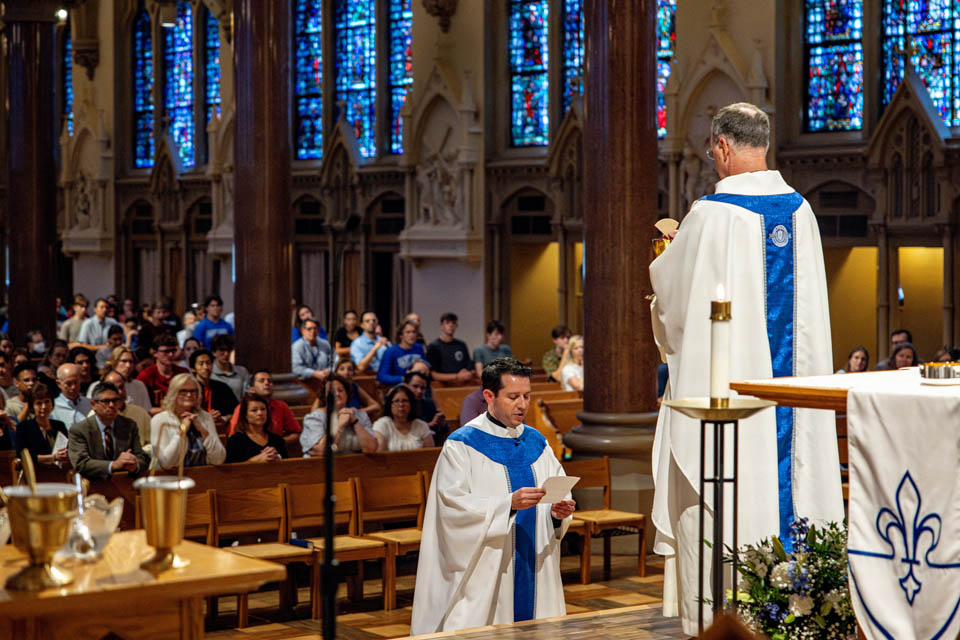 Michael Rozier, S.J., Ph.D., professes his final vows during the Mass of the Holy Spirit in St. Francis Xavier College Church on Thursday, Aug. 24. Photo by Sarah Conroy. 