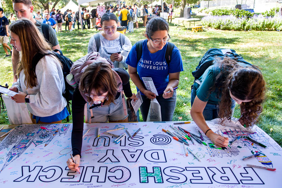 Students sign a banner during Fresh Check Day on Wednesday, Sept. 6. Photo Sarah Conroy.