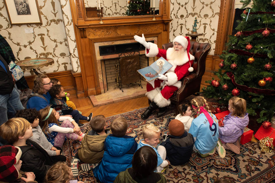 Santa reads to children as part of a Christmas on the Quad activity on Saturday, Dec. 9. Photo by Luke Yamnitz.