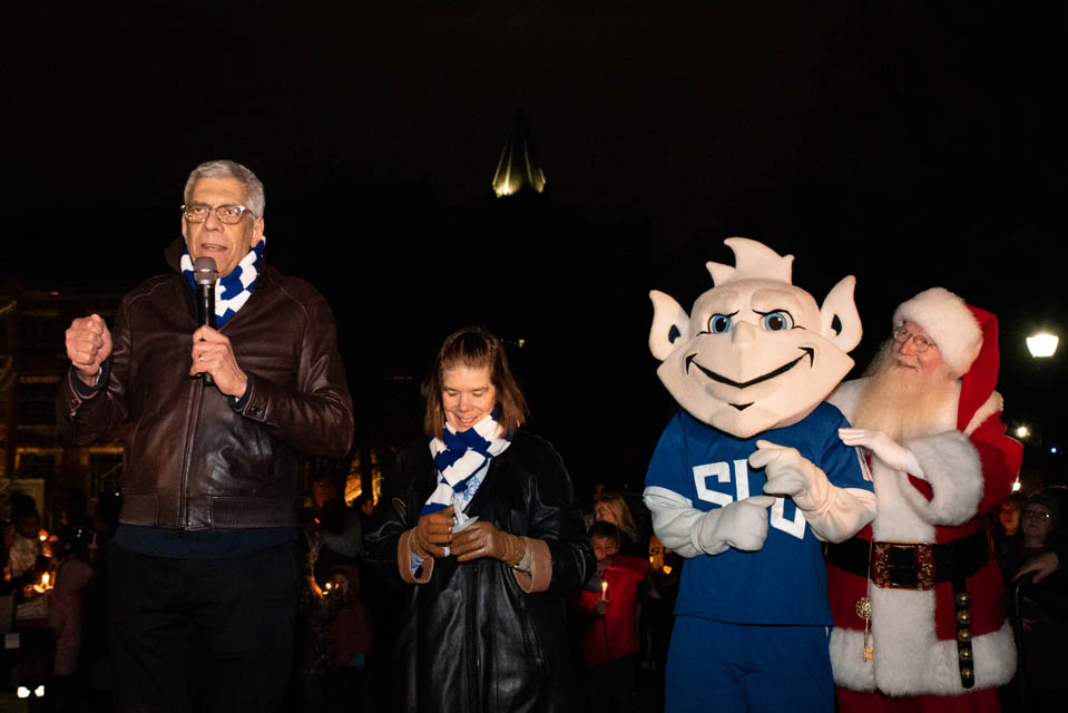 President Fred P. Pestello, Ph.D., First Lady Fran Pestello, Ph.D., the Billiken and Sanata address the crowd at Christmas on the Quad on Saturday, Dec. 9. Photo by Luke Yamnitz.