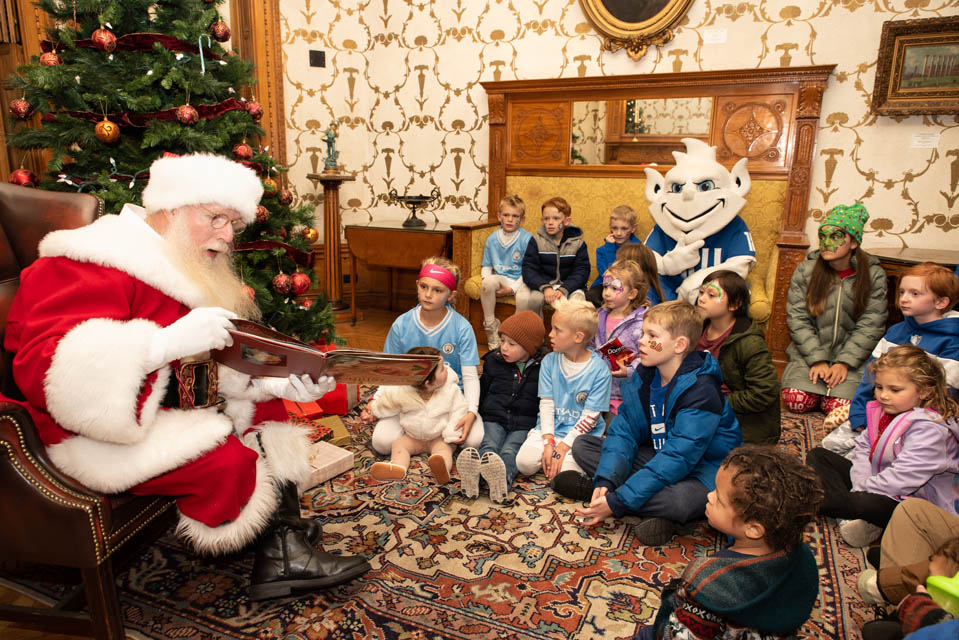 Santa reads to children and the Billiken in the Cupples House on Saturday, Dec. 9. Photo by Luke Yamnitz.