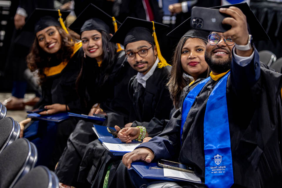 Graduates took a selfie during the Midyear Commencement on Saturday, Dec. 16, 2023. Photo by Sarah Conroy.