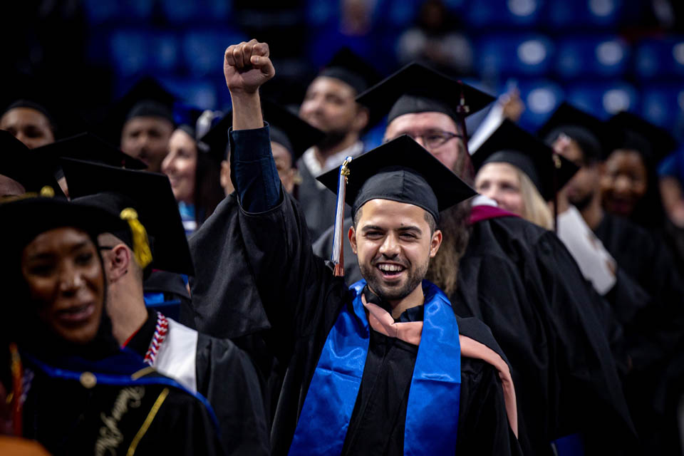 A graduate cheers during the Midyear Commencement on Saturday, Dec. 16, 2023. Photo by Sarah Conroy.