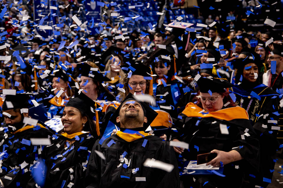 Graduates watch confetti fall following Midyear Commencement on Saturday, Dec. 16, 2023. Photo by Sarah Conroy.