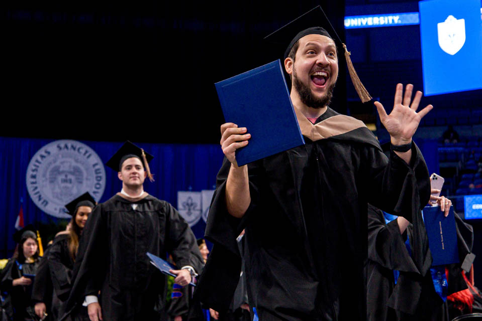 A graduate celebrates at the Midyear Commencement on December 16, 2023. Photo by Sarah Conroy.
