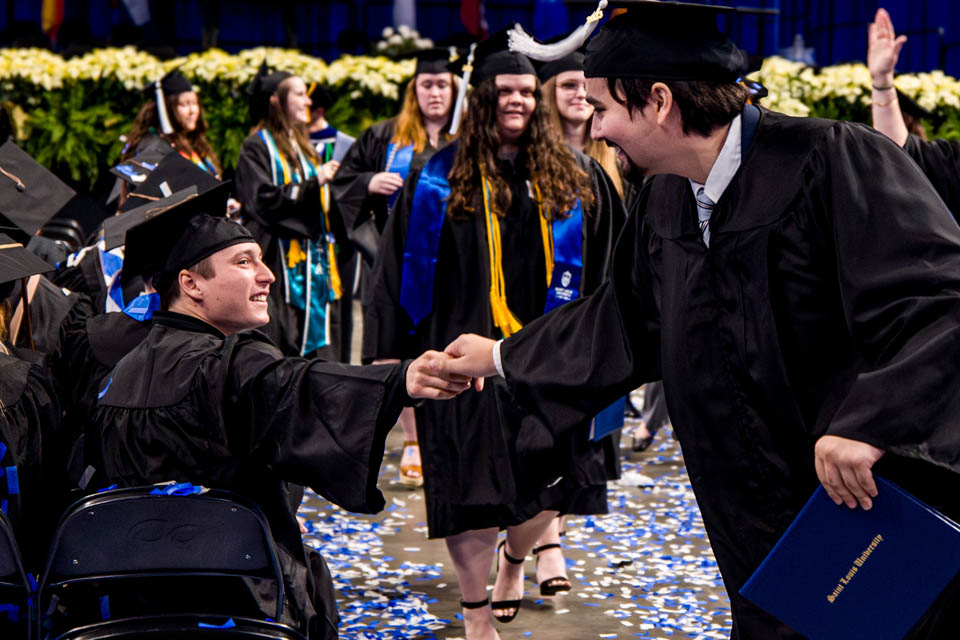 Graduates congratulate each other during the Midyear Commencement on Saturday, Dec.  16, 2023. Photo by Sarah Conroy.