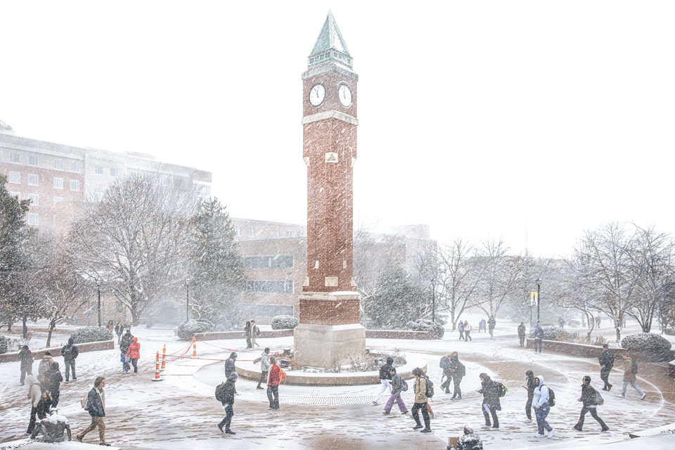 Students walk to class in the falling snow on Friday, Feb. 16, 2024. Photo by Sarah Conroy. 
