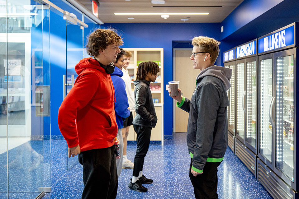 Swimmers Elijah Wilson (left) and Andrew Flight grab a smoothie and a snack in the Koman Family Fueling Station