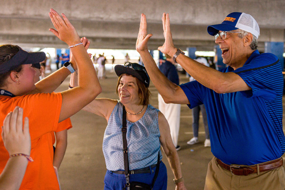 Presidential spouse Fran Pestello, Ph.D., and Saint Louis University President Fred P. Pestello, Ph.D., high-five students during move-in on Aug. 17, 2023, in SLU’s Laclede Parking Garage. Photo courtesy of Saint Louis University.