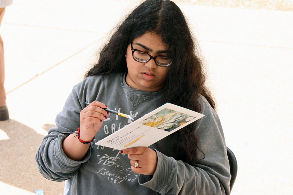 A student paints during Art Hives on Friday, April 5. Photo by Joe Barker.