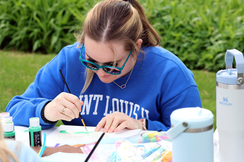 A student paints during Art Hives on Friday, April 5. Photo by Joe Barker.