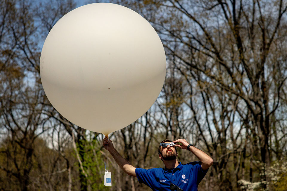 Carter Hickel prepares to launch a weather balloon during the solar eclipse at Trail of Tears State Park on April 8, 2024. Photo by Sarah Conroy. 
