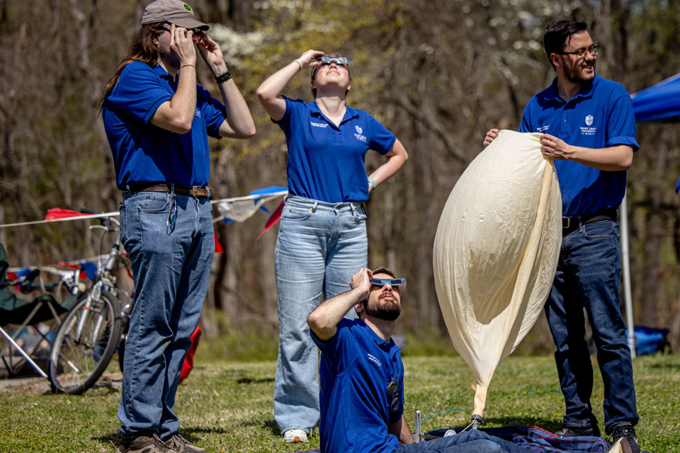 Pictured, from left, Jimmy Bergmann, Maggie Ideker, Jack Rotter, and Riley Jackson prepare to launch a weather balloon during the solar eclipse at Trail of Tears State Park on April 8, 2024. Photo by Sarah Conroy. 