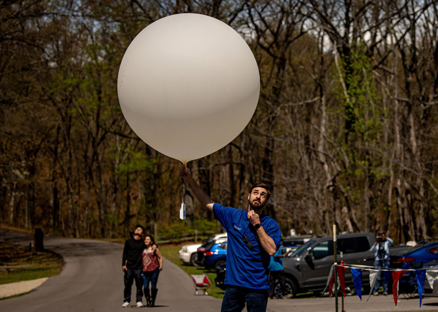 Carter Hickel prepares to launch a weather balloon during the solar eclipse at Trail of Tears State Park on April 8, 2024. Photo by Sarah Conroy. 