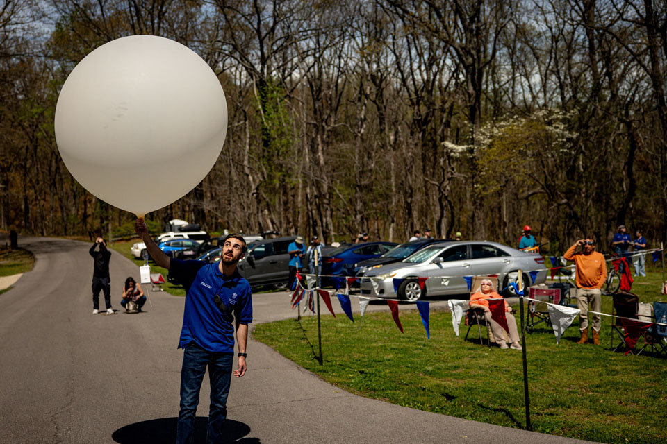 Carter Hickel prepares to launch a weather balloon during the solar eclipse at Trail of Tears State Park on April 8, 2024. Photo by Sarah Conroy. 
