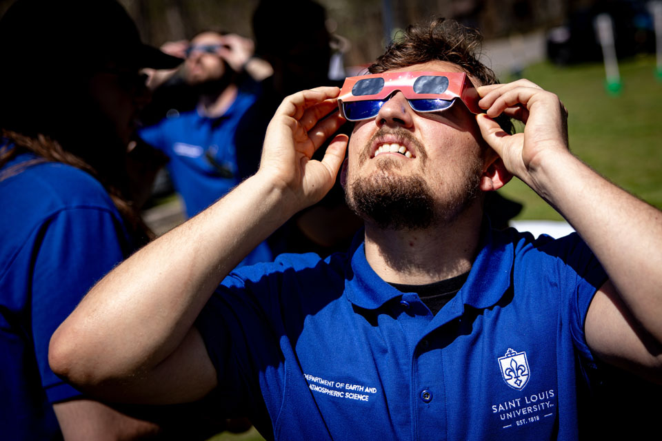 Benjamin Schaefer, a graduate student in meteorology at SLU, looks to the sky during the solar eclipse at Trail of Tears State Park on April 8, 2024. Photo by Sarah Conroy. 