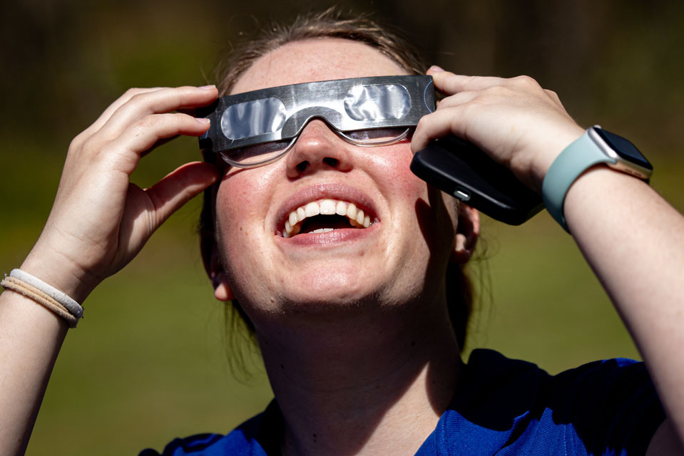 Maggie Ideker, a graduate student in meteorology, looks to the sky during the solar eclipse at Trail of Tears State Park on April 8, 2024.Photo by Sarah Conroy. 
