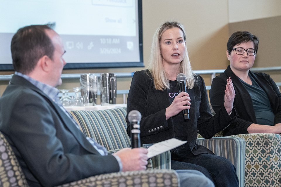 Joe Lyons, Ph.D., left, leads a panel on AI. Photo by Steve Dolan.