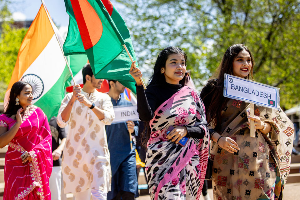 Members of the SLU community wave flags during the Parade of Nations as part of Atlas Week on April 12, 2024. Photo by Sarah Conroy.