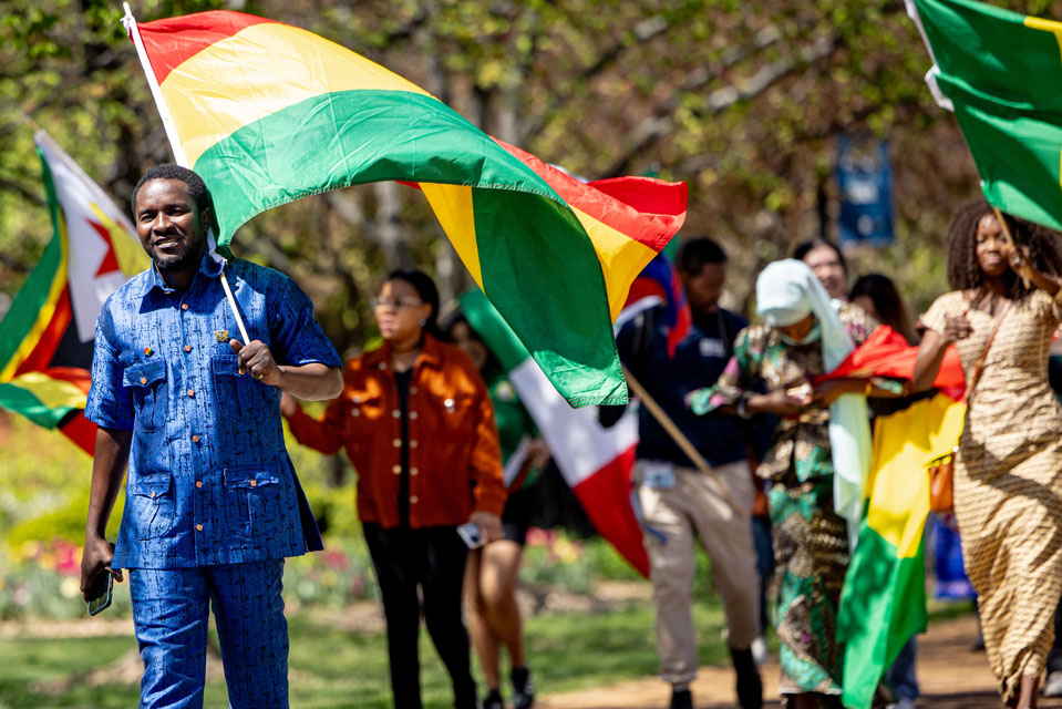 Members of the SLU community wave flags during the Parade of Nations as part of Atlas Week on April 12, 2024. Photo by Sarah Conroy.