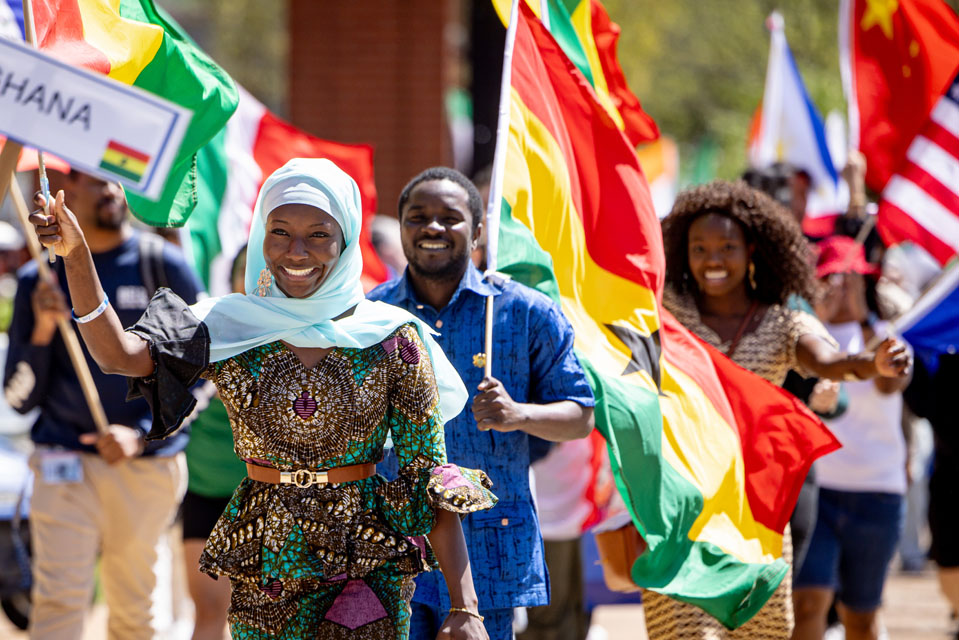 Members of the SLU community wave flags during the Parade of Nations as part of Atlas Week on April 12, 2024. Photo by Sarah Conroy.