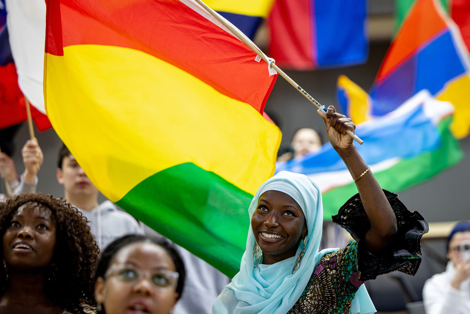 Members of the SLU community wave flags during the Parade of Nations as part of Atlas Week on April 12, 2024. Photo by Sarah Conroy.