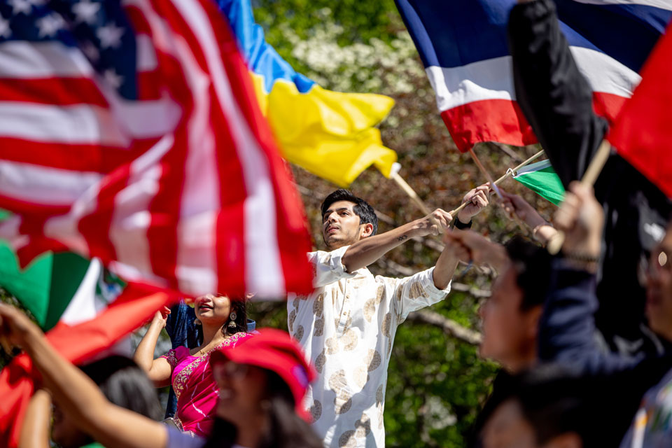 Members of the SLU community wave flags during the Parade of Nations as part of Atlas Week on April 12, 2024. Photo by Sarah Conroy.