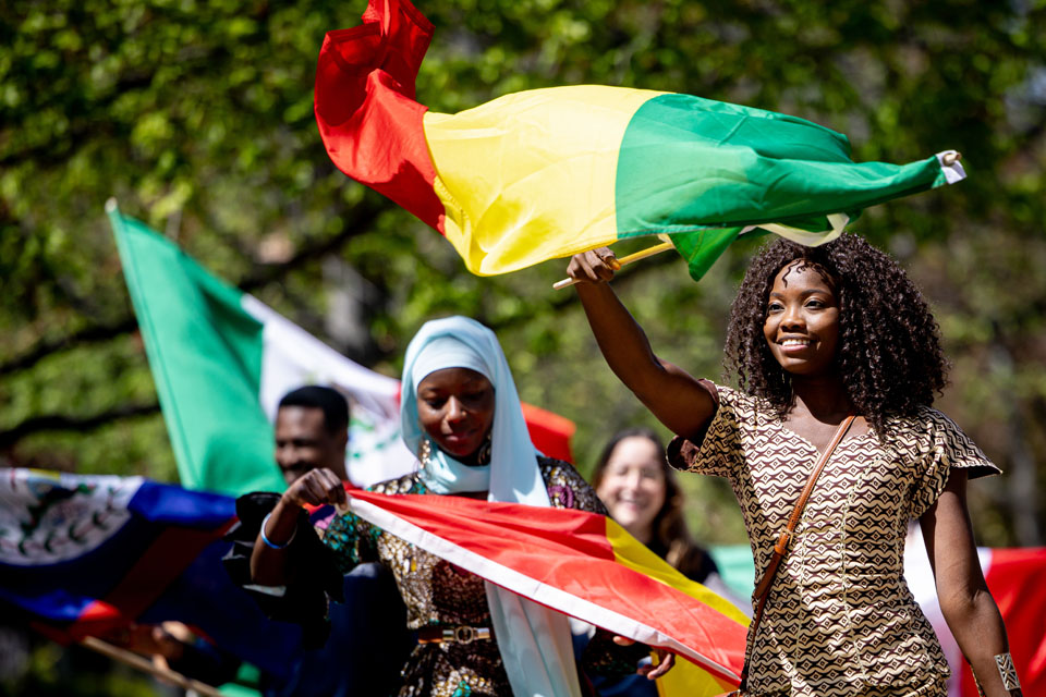 Members of the SLU community wave flags during the Parade of Nations as part of Atlas Week on April 12, 2024. Photo by Sarah Conroy.