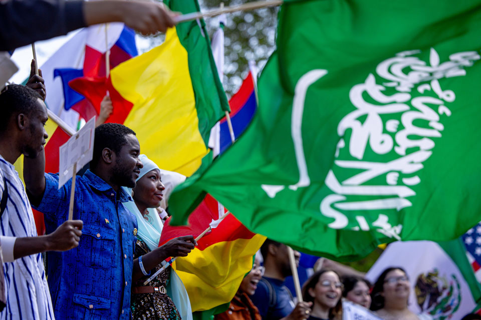 Members of the SLU community wave flags during the Parade of Nations as part of Atlas Week on April 12, 2024. Photo by Sarah Conroy.