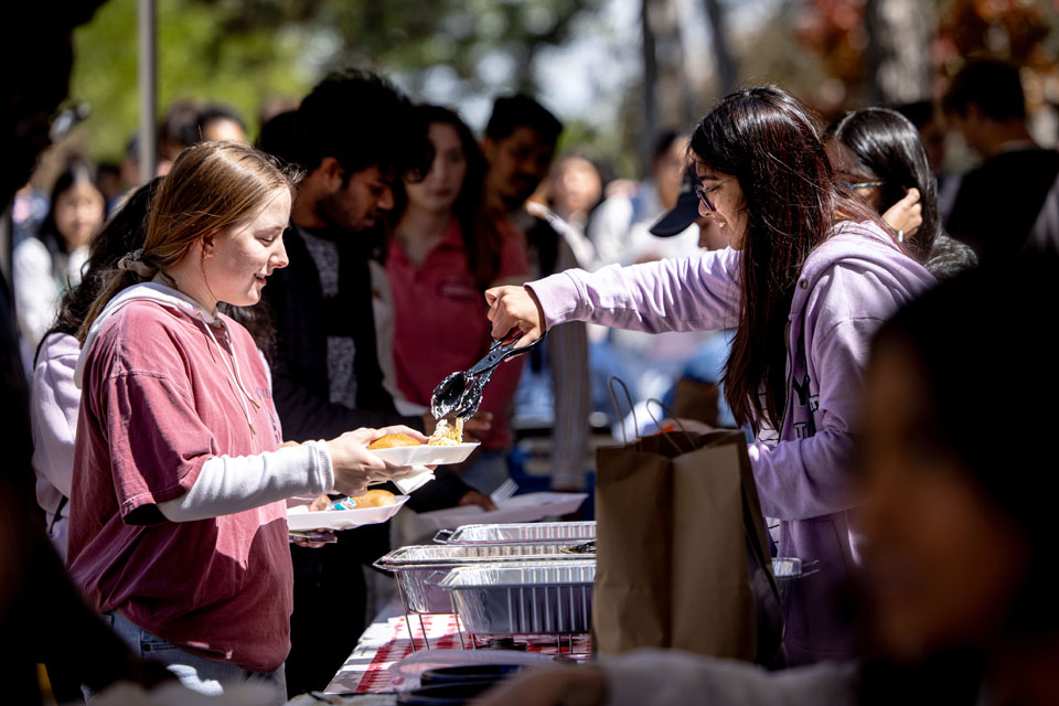 Students try different International cuisines at the Around the Globe: Clock Tower Market as part of Atlas Week on April 12, 2024. Photo by Sarah Conroy.
