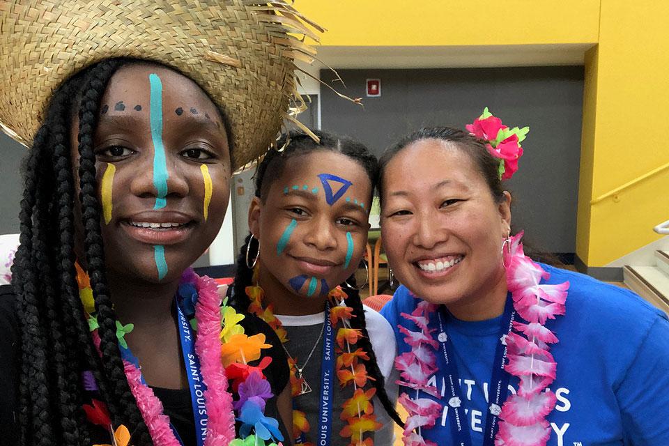 TRIO Program students pose with TRIO Talent Search academic coordinator member Marlene Wu (right) during the TRIO Talent Search's first Cultural Festival on July 16. Photo by Doris Hawkins