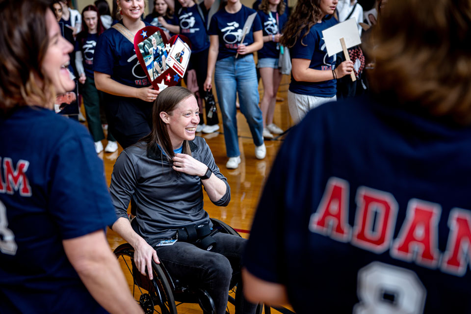Occupational Therapy faculty and students surprise Sarah Adam, Occupational Therapy professor and potentially the first female US wheelchair rugby Paralympian, front, with a celebration in her honor during DASA (Disabled Athlete Sports Association) Day on April 22, 2024. Photo by Sarah Conroy. 