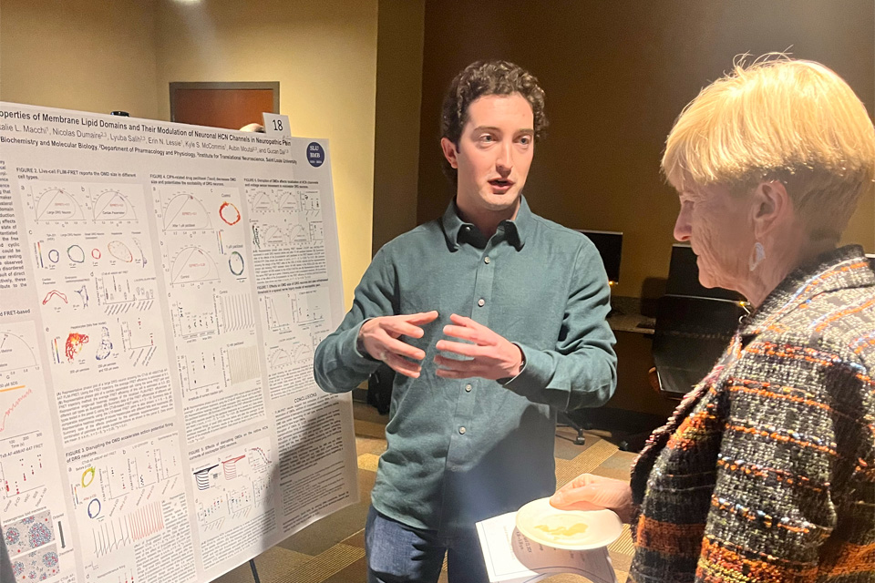 Christine Jacobs, M.D. speaks to one of the student researchers