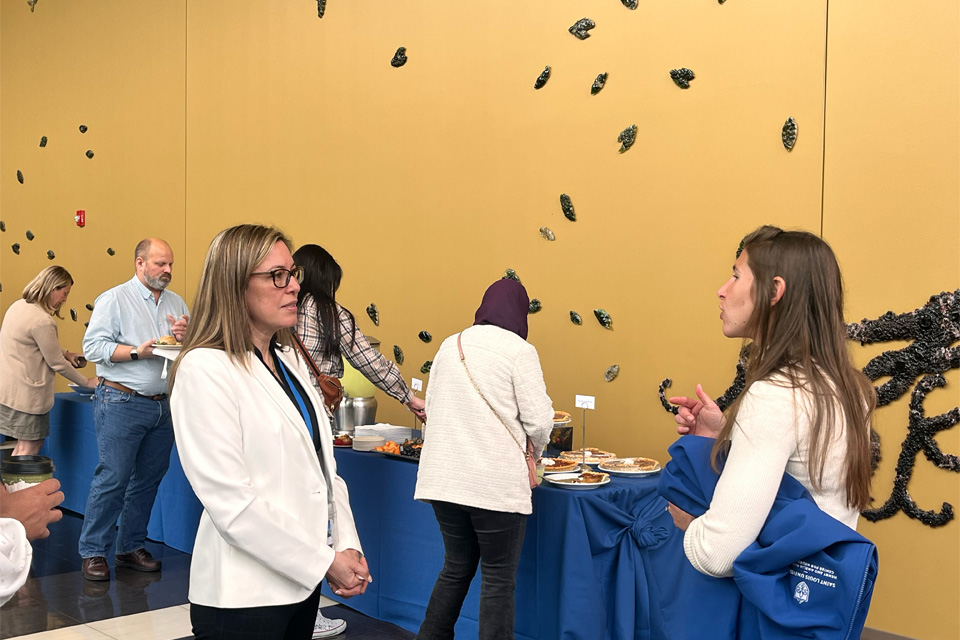 Adriana Montano, M.D. speaks to a fellow Science Day attendee
