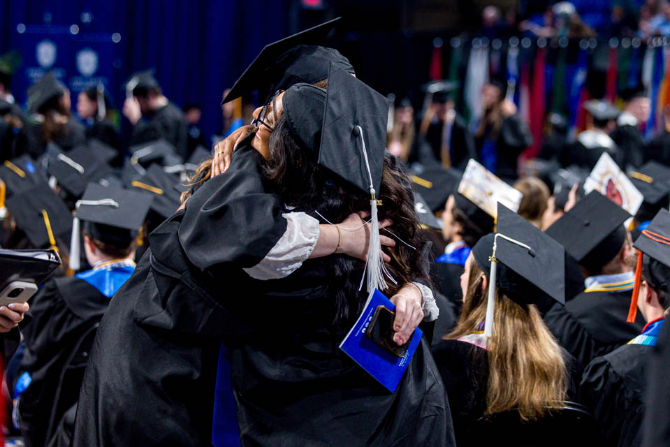 Graduates celebrate during Commencement on May 18, 2024. Photo by Sarah Conroy. 