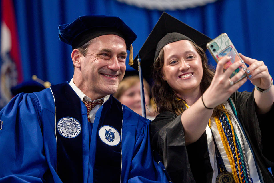Actor Jon Hamm takes a selfie with student speaker Sky Carroll during Commencement on May 18, 2024. Photo by Sarah Conroy. 