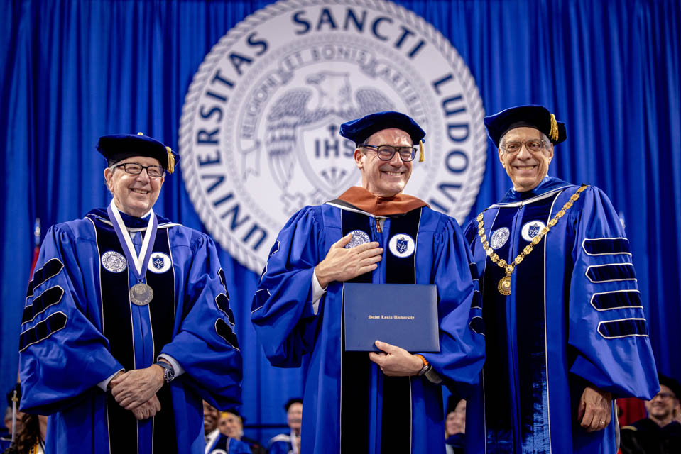 Actor Jon Hamm receives his honorary degree with Board of Trustees Chair Joseph Conran, left, and President Fred P. Pestello, Ph.D., right, during Commencement on May 18, 2024. Photo by Sarah Conroy. 
