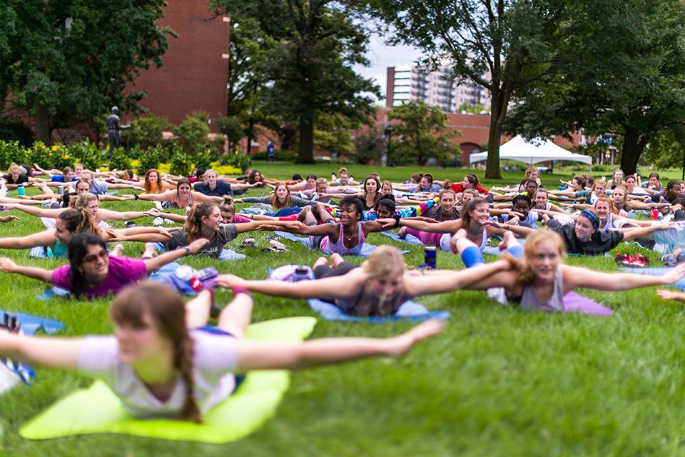 Students practiced yoga on the quad between Pius Library and DuBourg Hall. Photo by Garrett Canducci.