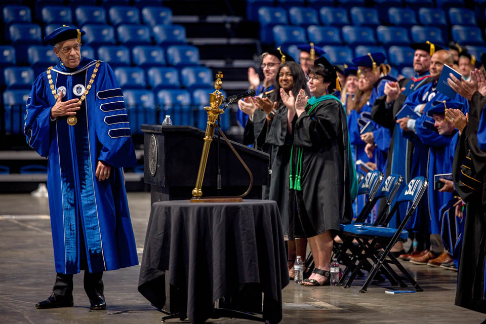 President Fred P. Pestello, Ph.D., receives a standing ovation from deans and Vice Presidents during Convocation on Aug. 17, 2024. Photo by Sarah Conroy. 