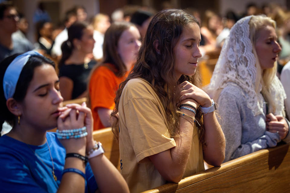 Students pray during the Mass of the Holy Spirit at St. Francis Xavier College Church on Aug. 22, 2024. Photo by Sarah Conroy.