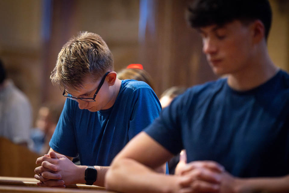 Students pray during the Mass of the Holy Spirit at St. Francis Xavier College Church on Aug. 22, 2024. Photo by Sarah Conroy.