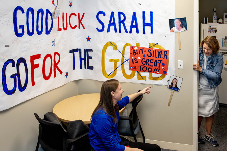 Sarah Adam, OTD, assistant professor of occupational science and occupational therapy, shows her Paralympic silver medal on her first day back to campus on Monday, Sept. 9, 2024. Adam made history as the first woman to represent the US Wheelchair Rugby team in the Paralympics and won a silver medal. Photo by Sarah Conroy.