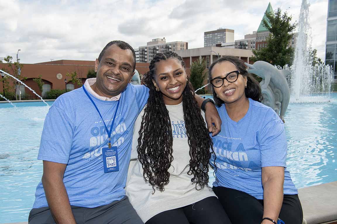 Family members pose near the Dolphin Pond during SLU's 2024 Homecoming and Family Weekend.