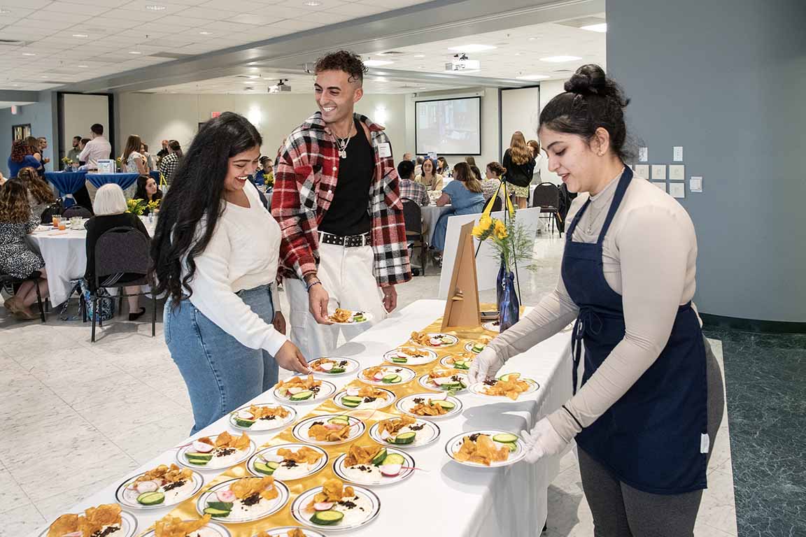 Attendees at the 2024 Gardens to Table events go through a buffet line.