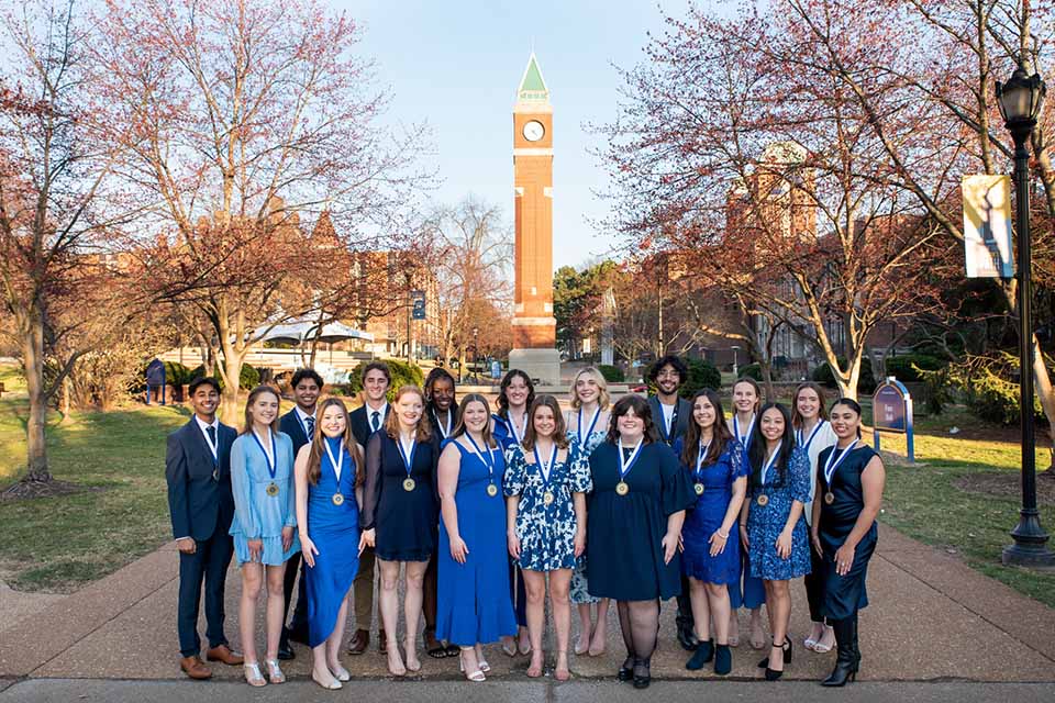Spirit of the Billiken Awardees pose for a photo in front of the clock tower. Photo by Luke Yamnitz. 